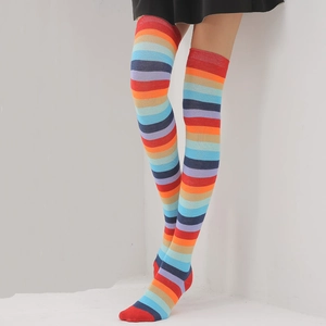 Detail of colorful striped over-the-knee socks with high elastic cuffs in a knitted texture