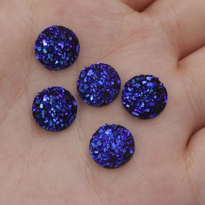 Macro shot of 10mm dark blue resin crystal cabochons for DIY jewelry making