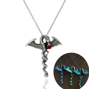 Luminous dragon necklace with red gem showing green and blue glow-in-the-dark effects