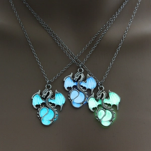 Luminous dragon pendant necklaces glowing in cyan, sky blue and green in the dark