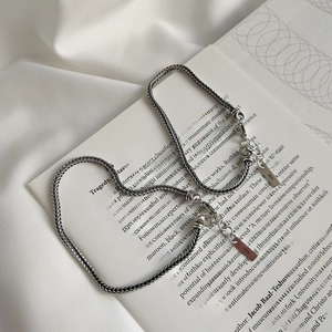 Detail of vintage S925 sterling silver woven bracelet with lobster clasp on a book
