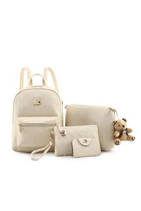 Detail view of 4-piece cream backpack set with textured faux leather and bear charm