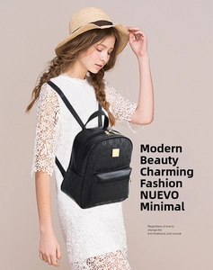 Detail of black embossed leather mini backpack with gold hardware on an elegant model