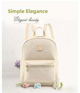 Detail of cream backpack with embossed ring pattern and elegant gold hardware