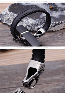Detail of 316L stainless steel dragon head clasp on black braided leather bracelet