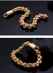 Detailed view of punk style skull link bracelet with secure metal clasp in gold finish