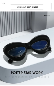Macro shot of futuristic black chunky cat-eye glasses on a minimalist white platform