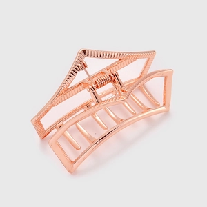 Macro shot of rose gold geometric hair claw clip showing hollow metal design details
