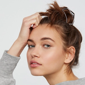 Silver hollow geometric metal hair claw clip shown on a model with a clean minimalist style