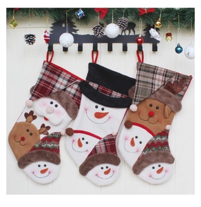 Close-up of three festive Christmas stockings with Santa, reindeer, and snowman patterns