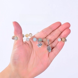 Detail showing the durable elastic rope of the amazonite bead bracelet stretched by hand