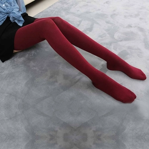 Detailed close-up of wine red knitted over-knee cotton thigh high socks for women