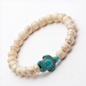 Detail of white stone beads and blue turtle charm for bohemian vacation bracelet