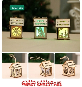 Close-up of small LED wooden house ornaments with Santa and reindeer cutout patterns