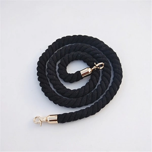 Detail of black braided rope shoulder strap with gold metal hooks on white background