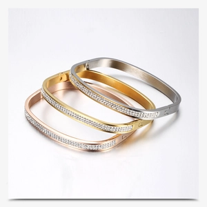 Detail of square stainless steel bracelets in gold, silver, and rose gold with rhinestones