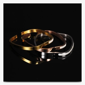 Close-up of three-tone square stainless steel bracelets with double-row crystal inlays