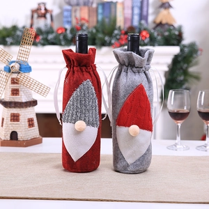 Festive Christmas gnome wine bottle covers in red and grey knit fabric for table decor