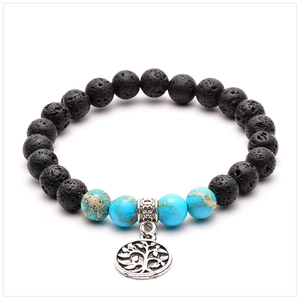 Detail of lava rock yoga bracelet with blue stones and a silver Tree of Life charm