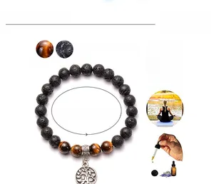 Detail of 8mm tiger eye and lava stone beads bracelet with a tree of life charm