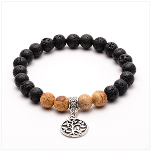 Detailed close-up of volcanic lava stone beads and Tree of Life pendant on yoga bracelet