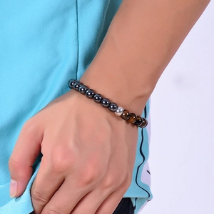 8mm tiger eye and hematite beaded bracelet with silver metal bead on male wrist