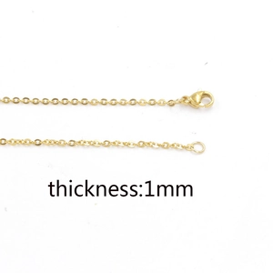 Detail view of 1mm gold stainless steel cross chain with secure lobster clasp closure
