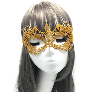 Close-up of champagne gold lace masquerade mask with sparkling rhinestones details