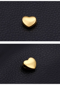 Macro detail of gold heart-shaped stainless steel beads for DIY jewelry making