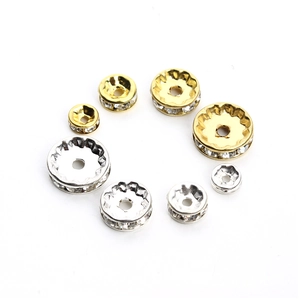 Detailed close-up of gold and silver rhinestone spacer beads in multiple sizes for DIY jewelry