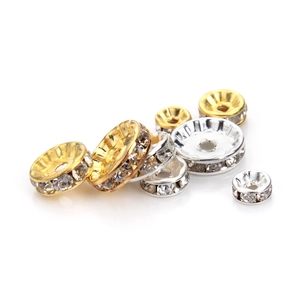 Macro shot of gold and silver plated spacers with inlaid clear rhinestones for DIY jewelry