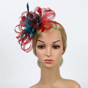 Detail of red and green mesh fascinator hat with feathers and beads for weddings
