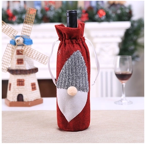 Detailed close-up of a Christmas gnome wine bottle cover with grey knit hat and white beard