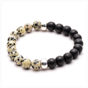 Detail shot of 8mm matte black lava stone and Dalmatian Jasper beads on elastic bracelet