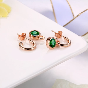 Elegant C-shaped earrings in rose gold with emerald green round crystal pendants