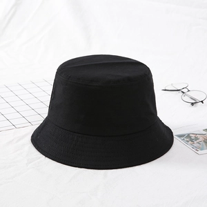 Top view of a plain black cotton bucket hat with flat top and fine stitching details