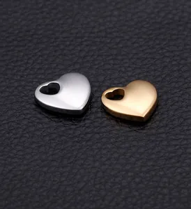 Macro detail of heart pendants in gold and silver finish with heart-shaped cutouts