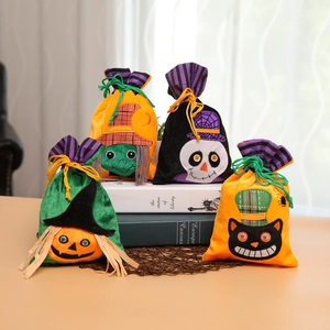 Macro shot of Halloween velvet drawstring bags with pumpkin and witch embroidery