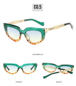 Detailed view of cat-eye sunglasses with green leopard frame and gold metal chain temples