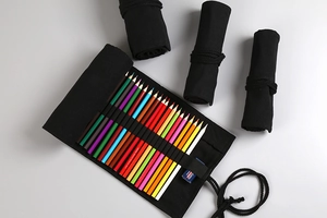 Detail view of black canvas roll-up pencil wrap with elastic slots and tie closure