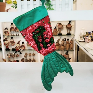 Detail of mermaid tail Christmas stocking with red and green reversible sequins and letter R