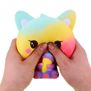 Close-up of hands squeezing a soft slow-rebound colorful fox toy with ice cream cone