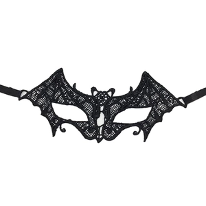 Detail of black embroidered lace mask in bat wing shape with elastic strap for Halloween