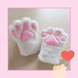 White plush cat paw gloves with pink pads displayed on a wooden surface for cosplay