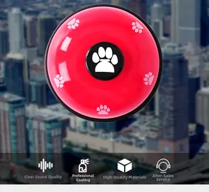 Detail of red metal pet training bell with paw print design and crisp sound feature