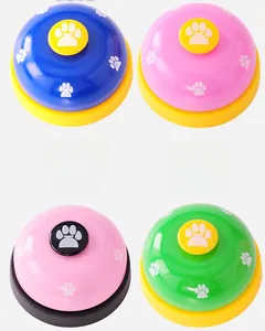Detail view of colorful pet training bells with paw prints in blue pink and green