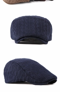 Detail of navy blue knitted ivy cap with classic cable-knit texture for winter