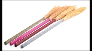 Detail of glitter witch brooms in gold, pink, burgundy and silver for Halloween cosplay