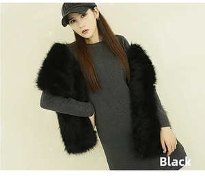 Detail of soft black faux fur shawl draped over a casual winter knit dress