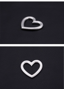 Detailed macro view of heart-shaped hollow stainless steel pendant with silver polished finish